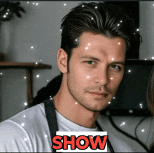 a man in a white shirt with the word show in red letters