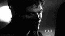 a black and white photo of a man 's face with a blurry background .