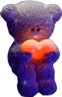 a teddy bear is holding an orange heart