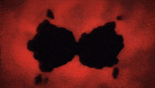 a silhouette of a person 's face with a red background