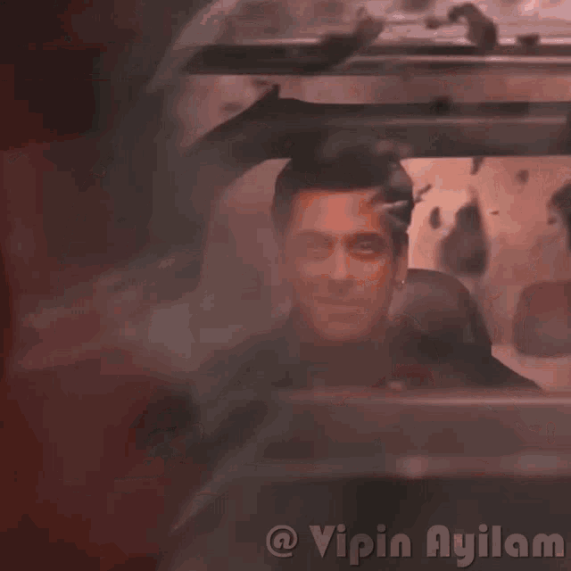 a picture of a man in a car with the words vipin ayilam on the bottom