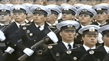 a group of men in military uniforms are standing in a row