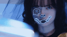 a close up of a woman 's face with a smiley face painted on it
