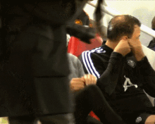 a man wearing a black jersey with the letter a on the front