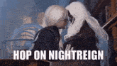 a man and a woman are kissing in a library and the man is saying `` hop on nightreign '' .