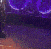 a person playing a guitar on a stage in front of a drum set
