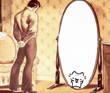a man looks at himself in a mirror with a cat drawn on it