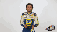 a man in a napa auto parts shirt is giving a thumbs up .