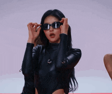 a woman wearing sunglasses and a black top
