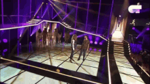 a group of people are standing on a stage with a sign that says ' jc ' on it