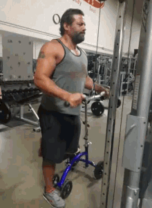 a man is using a machine in a gym that has the word body on the wall