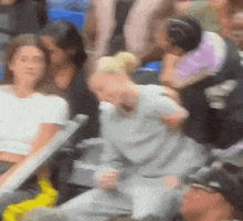 a blurry picture of a crowd of people watching a basketball game