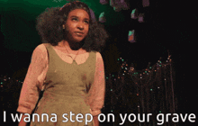 a girl on stage with the words i wanna step on your grave