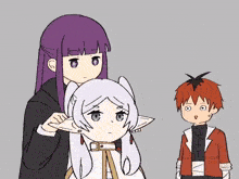 a girl with purple hair is adjusting a girl 's ear