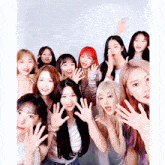 a group of young women are posing for a picture with their hands up