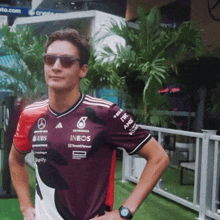 a man wearing sunglasses and a shirt that says ubs on it