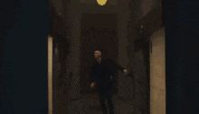 a person is standing in a dark room with a leopard print shirt on .