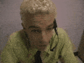 a man wearing a headset says hello to the camera