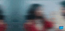 a blurry picture of a woman in a red dress with the word hk on the bottom