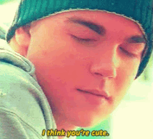 a close up of a man 's face with the words i think you 're cute