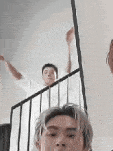 a man is standing on a set of stairs with his arms outstretched .