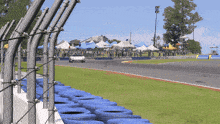 a car is driving down a race track with a michelin sign in the background