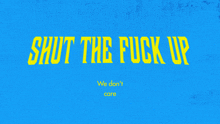 a blue sign that says shut the fuck up