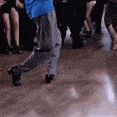 a group of people are dancing on a dance floor .