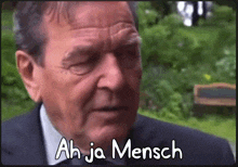 a man in a suit says ah ja mensch on the screen