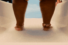a woman 's feet are shown on a slide wearing sandals