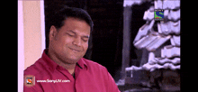 a man is smiling in front of a sony logo