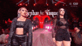 a couple of women standing on a stage with the name stephanie vaque written on it