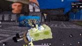 a spongebob squarepants character is playing a video game on a phone .