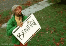 a man is holding a sign that says `` beautiful '' in front of a sidewalk .