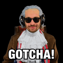 a man wearing a wig and sunglasses is sitting in a chair and says gotcha