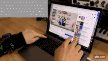 a person is typing on a laptop with a youtube video open on the screen