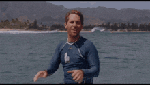 a man standing in the water with the words when life give