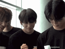 a group of young men are standing next to each other and one of them is wearing a black shirt that says yumaglobalteam