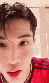 a close up of a man wearing a red shirt