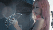 a woman with pink hair is holding a bow and arrow in her hand