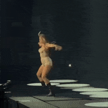 a naked woman is dancing on a stage