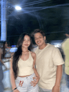 a man and a woman are posing for a picture in a blurry photo