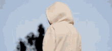 a woman wearing a hoodie that says ivy park on the front