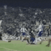 a group of soccer players are playing on a field with an ad for toyota