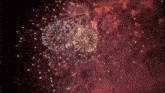 a fireworks display in the night sky with a red background