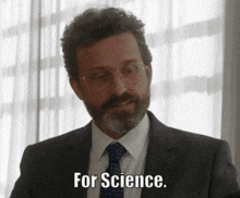 a man with glasses and a beard says for science