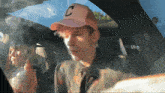 a man wearing a hat with the letter c on it