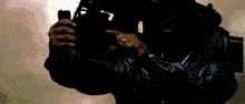 a blurry picture of a person holding a cell phone with the number 11 on it