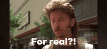 a man with a mullet says " for real " in front of a building