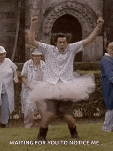 a man in a tutu is dancing in front of a group of older people .
